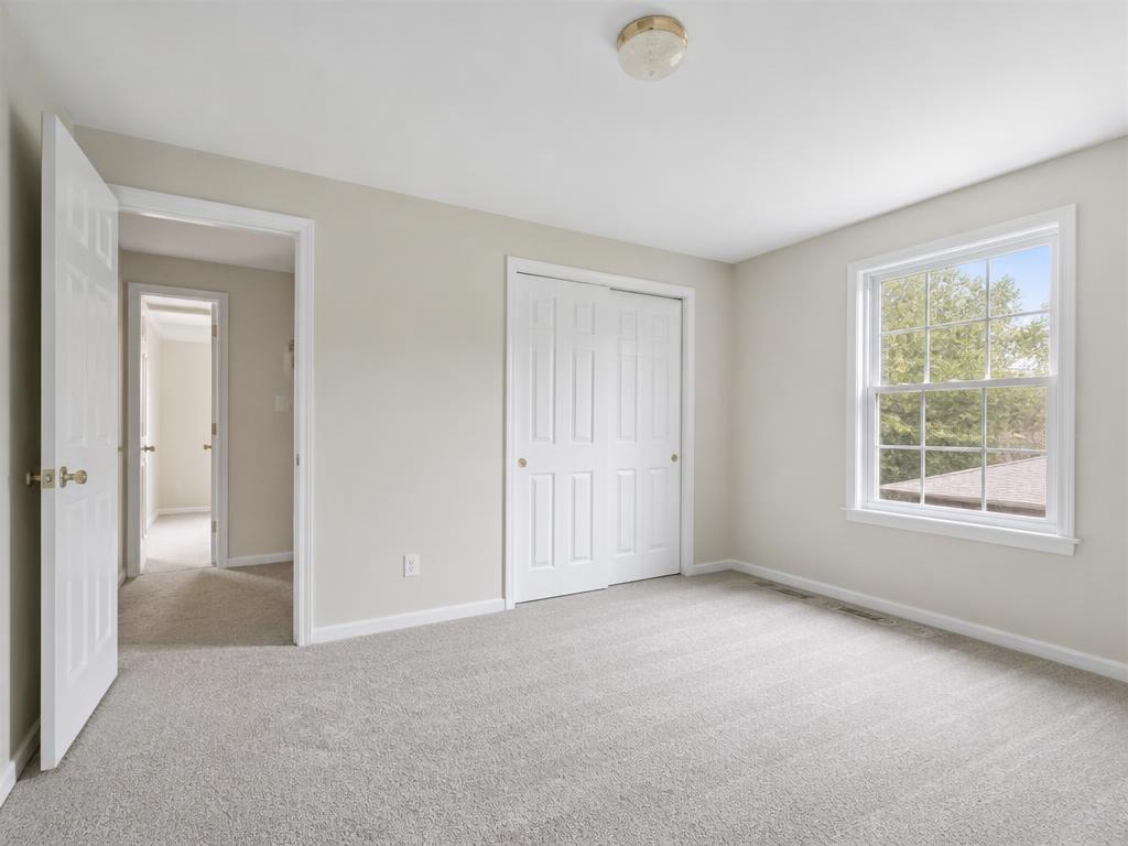 Restored bedroom with clean painted walls and new carpet after fire damage repair