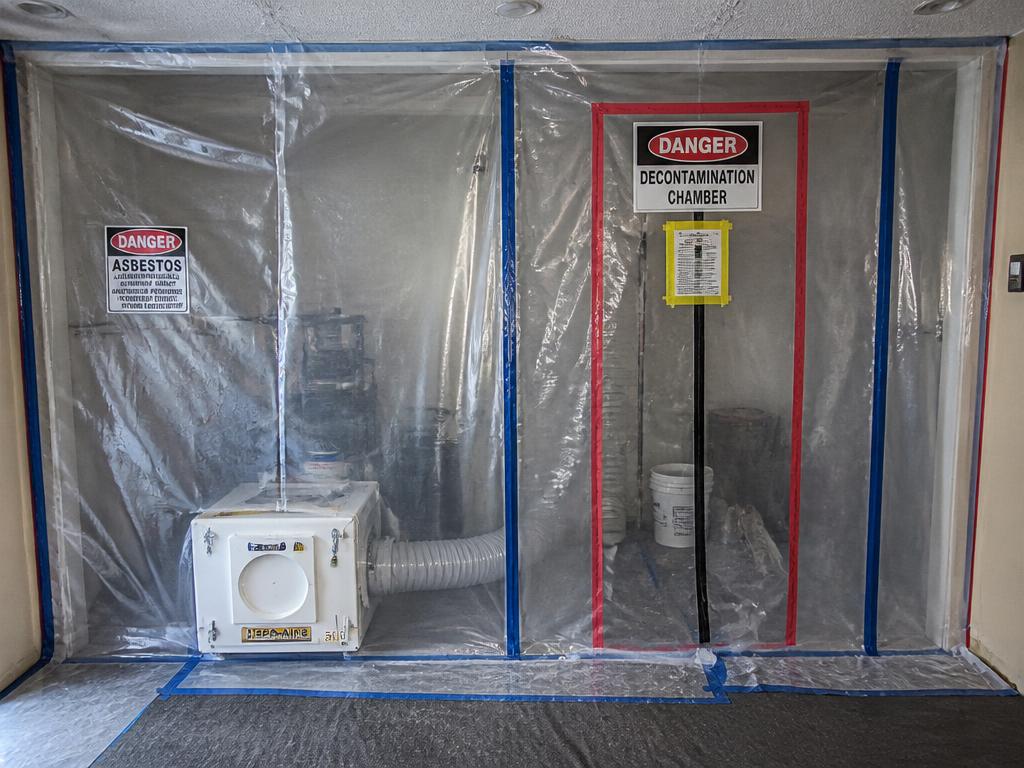 Sealed asbestos containment enclosure with negative air machine