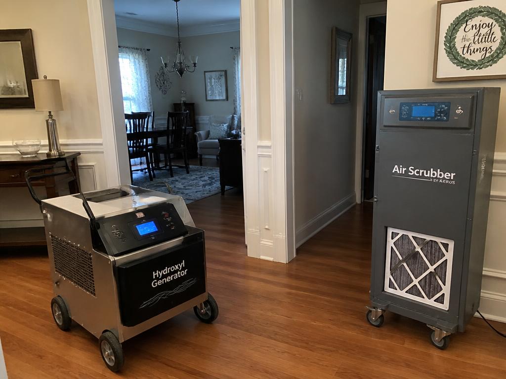 Hydroxyl generator and air scrubber removing smoke odor from a house interior