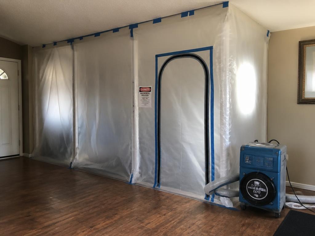 Plastic containment barrier and negative air machine set up for mold remediation