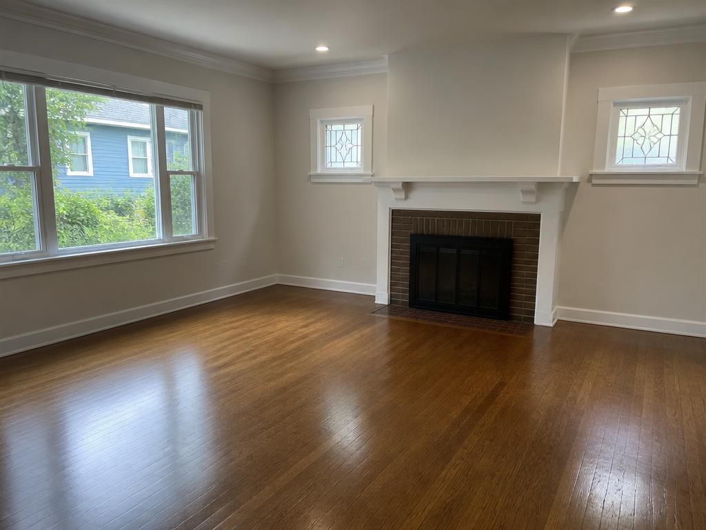 Restored living room with refinished hardwood flooring after water damage repair